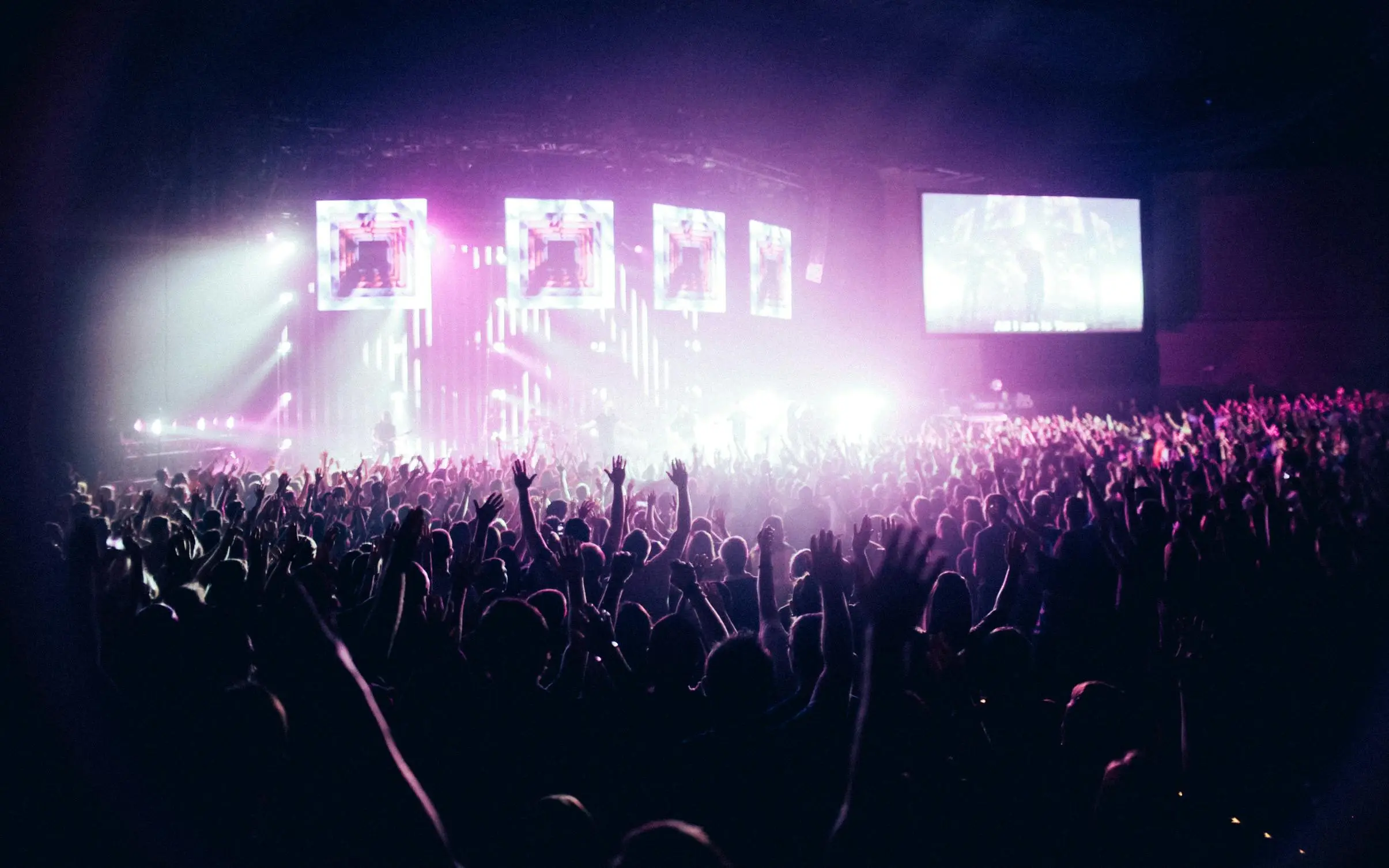 a crowd of people in front of a stage